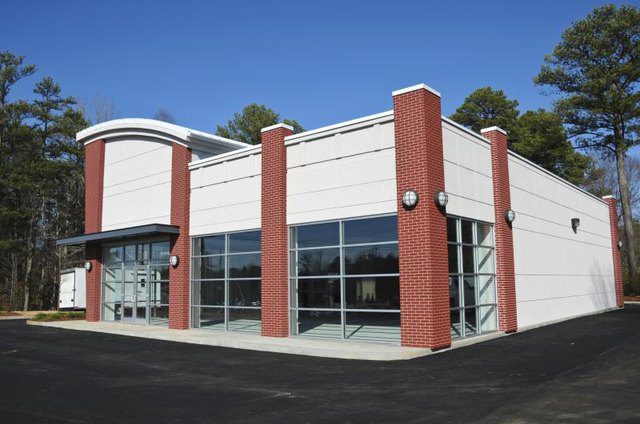 A large building with glass windows and red brick.